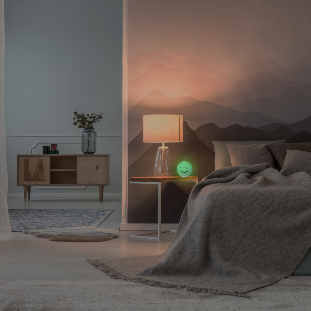 Green-glowing Stone HRV biofeedback device on a nightstand in a calm dusk bedroom for sleep and relaxation
